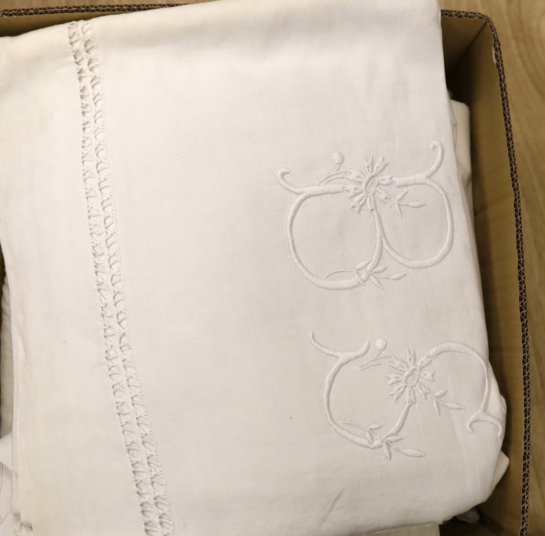 A collection of eight French provincial coarse linen sheets with embroidered and monogrammed turnbacks